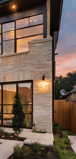 A large house with a lot of windows and a wooden fence.
