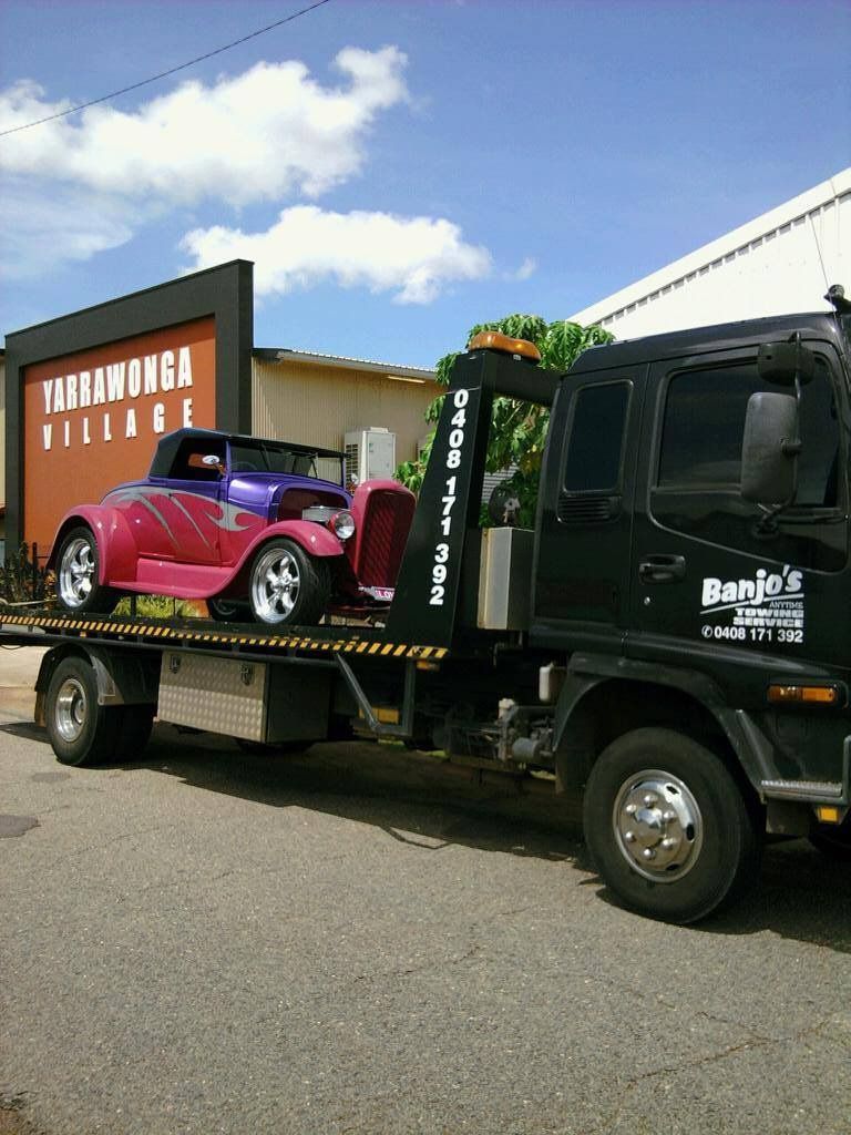 A Tow Truck Carrying a Custom, Purple and Pink Hot Rod — Banjo's Anytime Towing in Coolalinga, NT