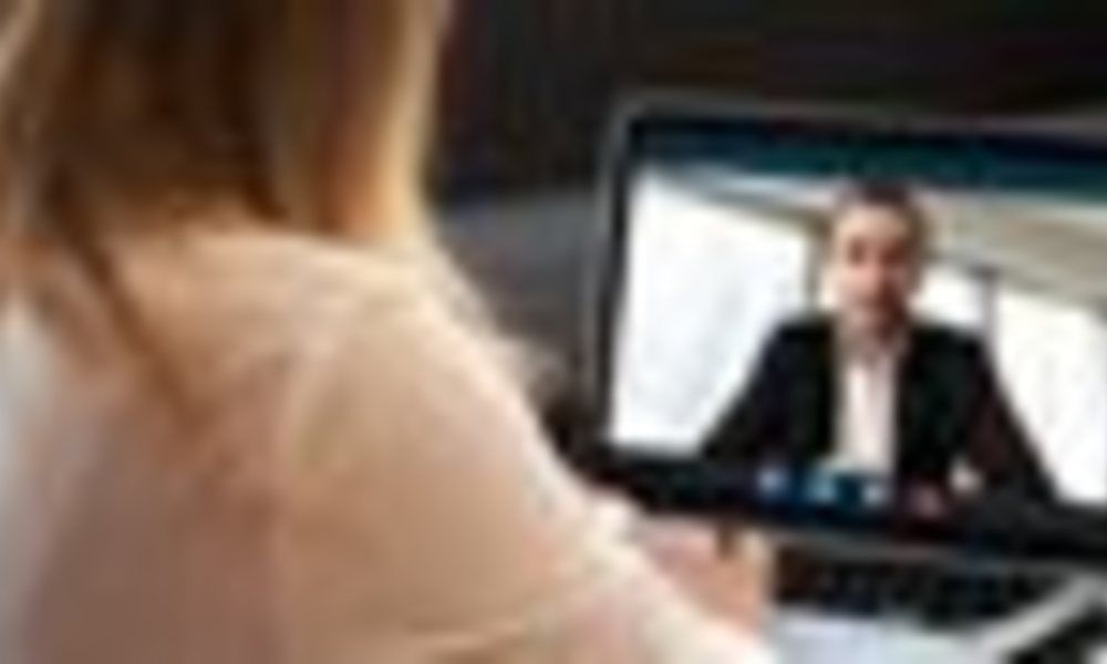 A woman is having a video call on a laptop computer.