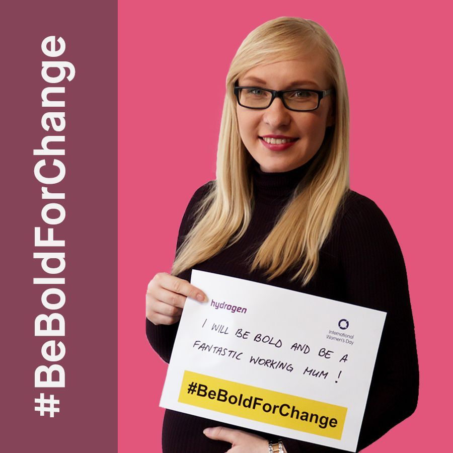 A woman is holding a sign that says be bold for change