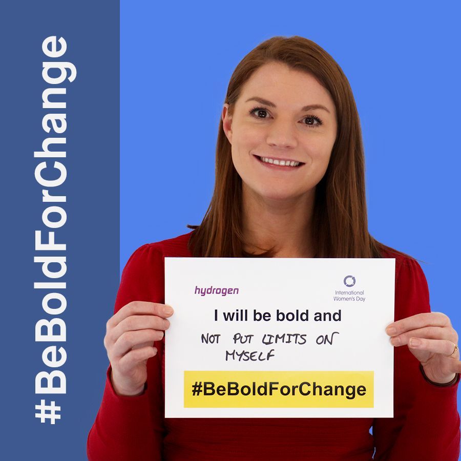 A woman is holding a sign that says i will be bold and not put limits on myself