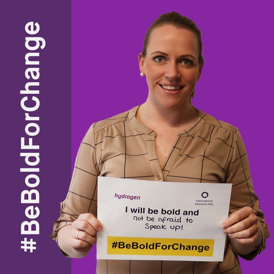 A woman is holding a sign that says i will be bold and not be afraid to speak up.
