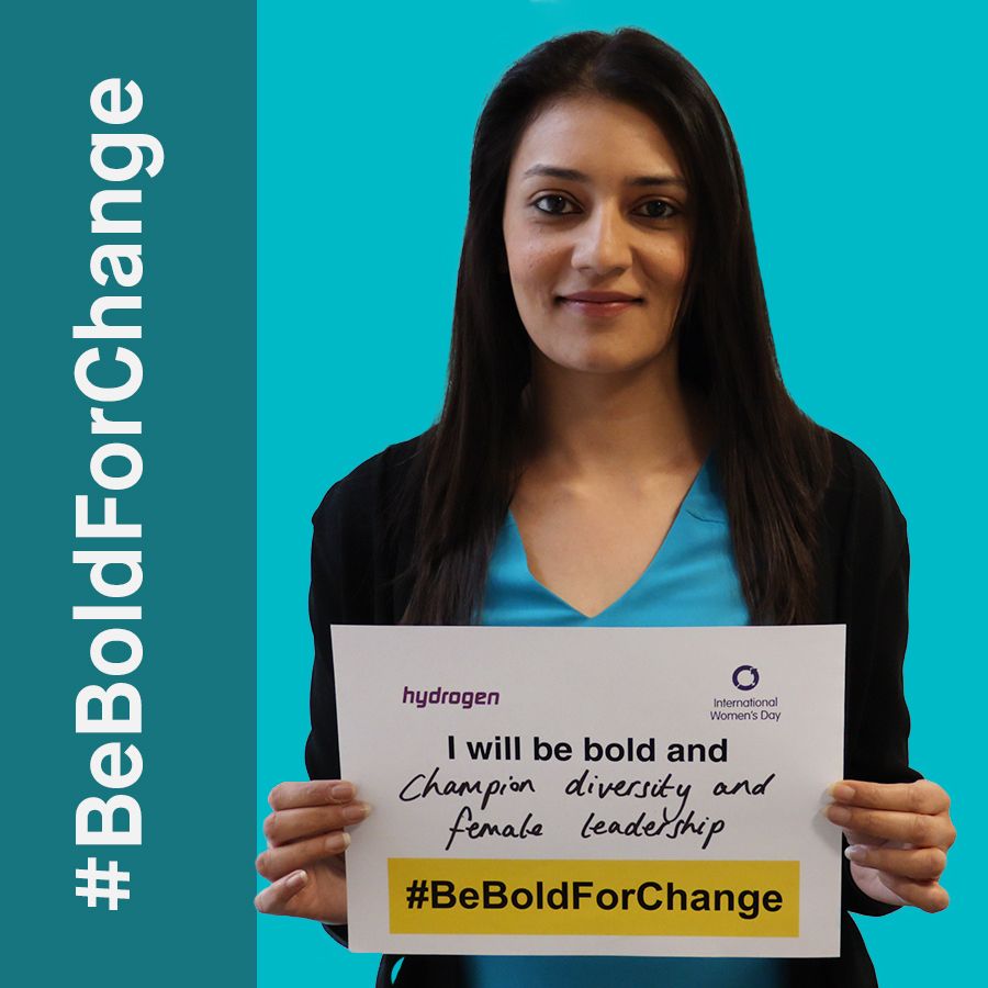 A woman is holding a sign that says i will be bold and champion diversity and female leadership
