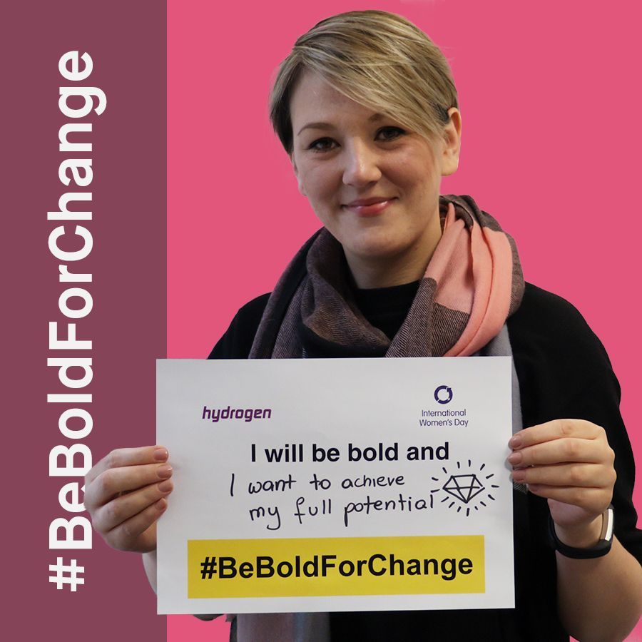 A woman is holding a sign that says i will be bold and i want to achieve my full potential