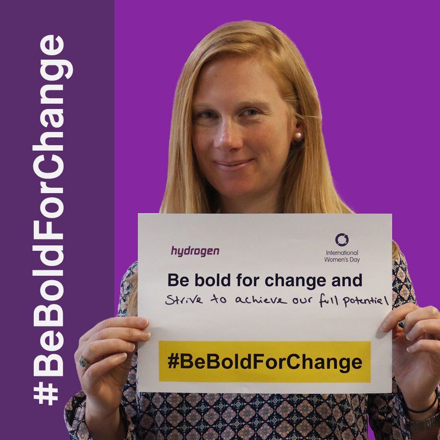 A woman is holding a sign that says be bold for change
