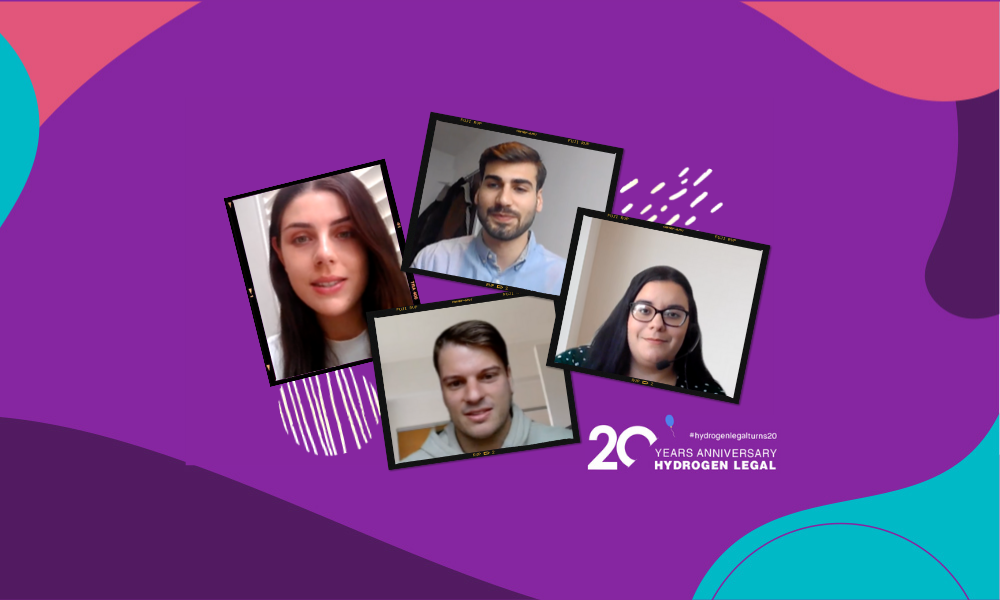 A group of people are sitting in front of a purple background.