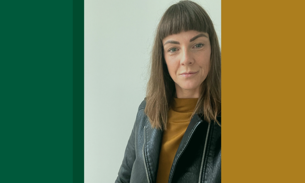 A woman wearing a leather jacket and a yellow shirt is standing in front of a green and yellow background.