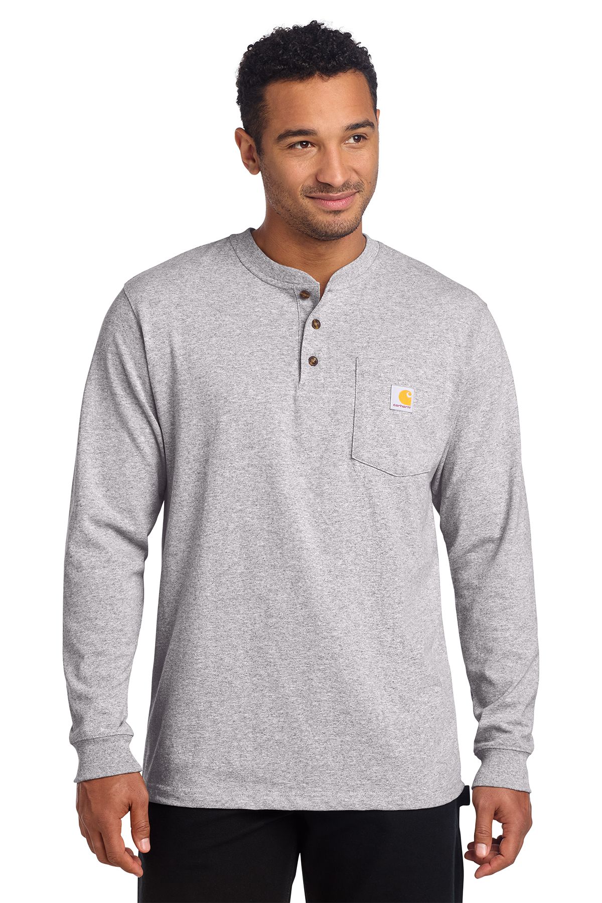 Man wearing a black long-sleeved Henley shirt with a chest pocket, smiling.