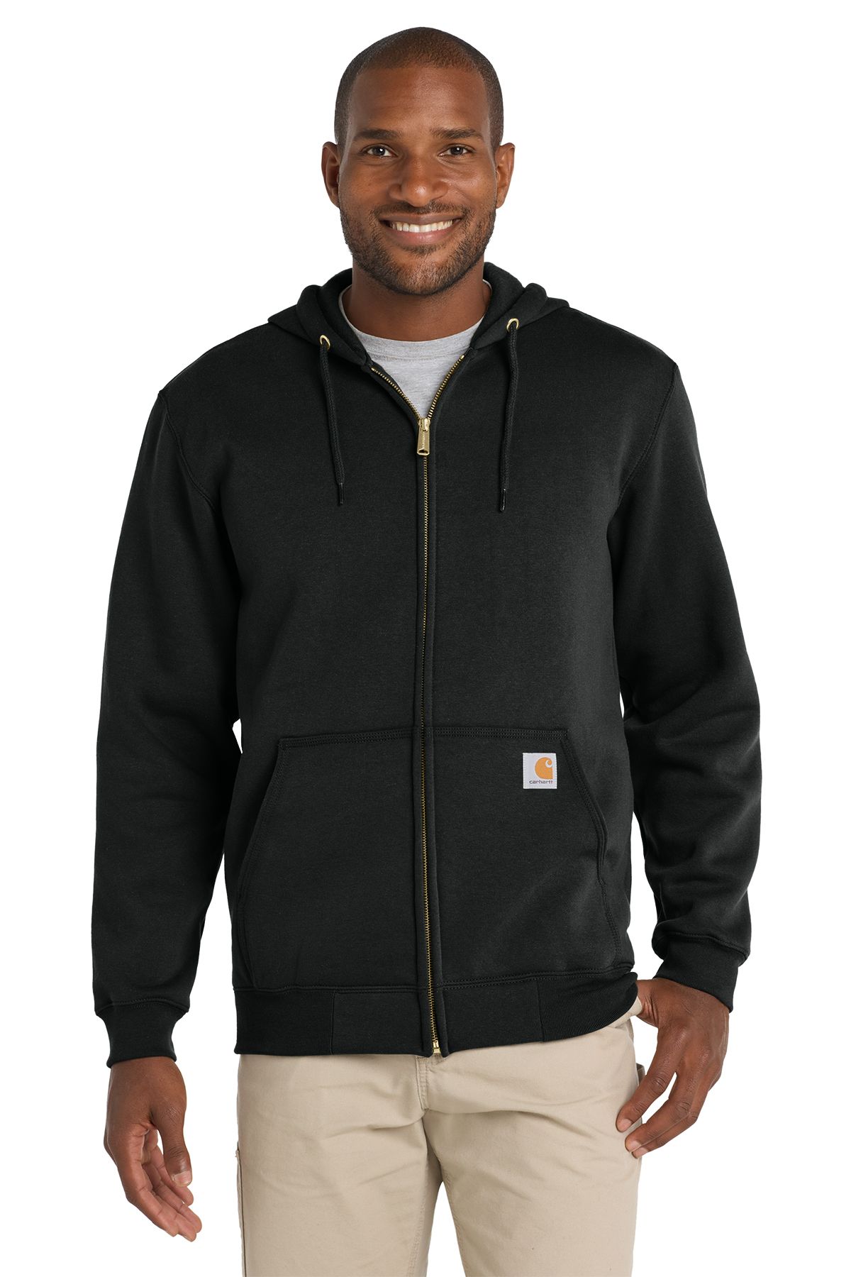 Man in black Carhartt zip-up hoodie and khaki pants.