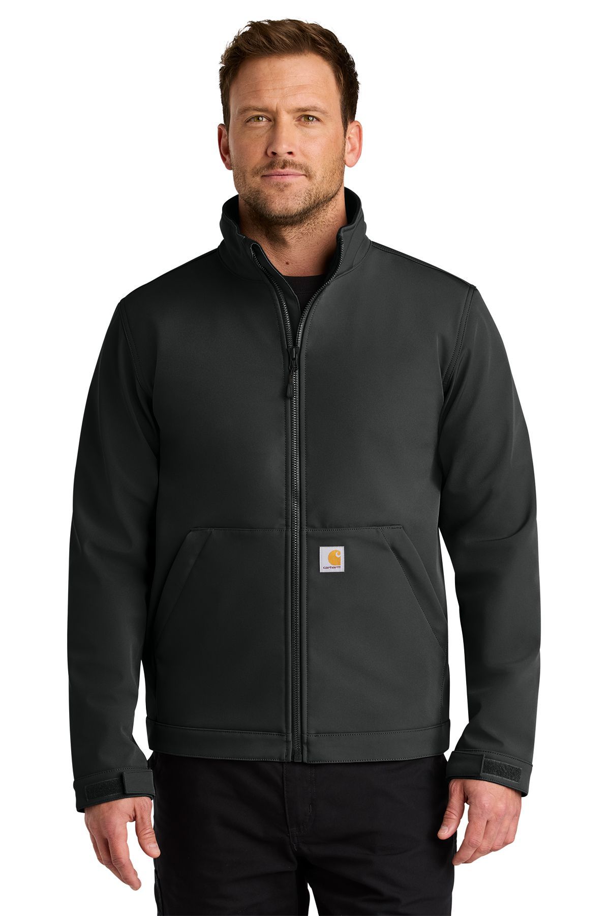 Man wearing a black Carhartt jacket, standing in front of a white background.