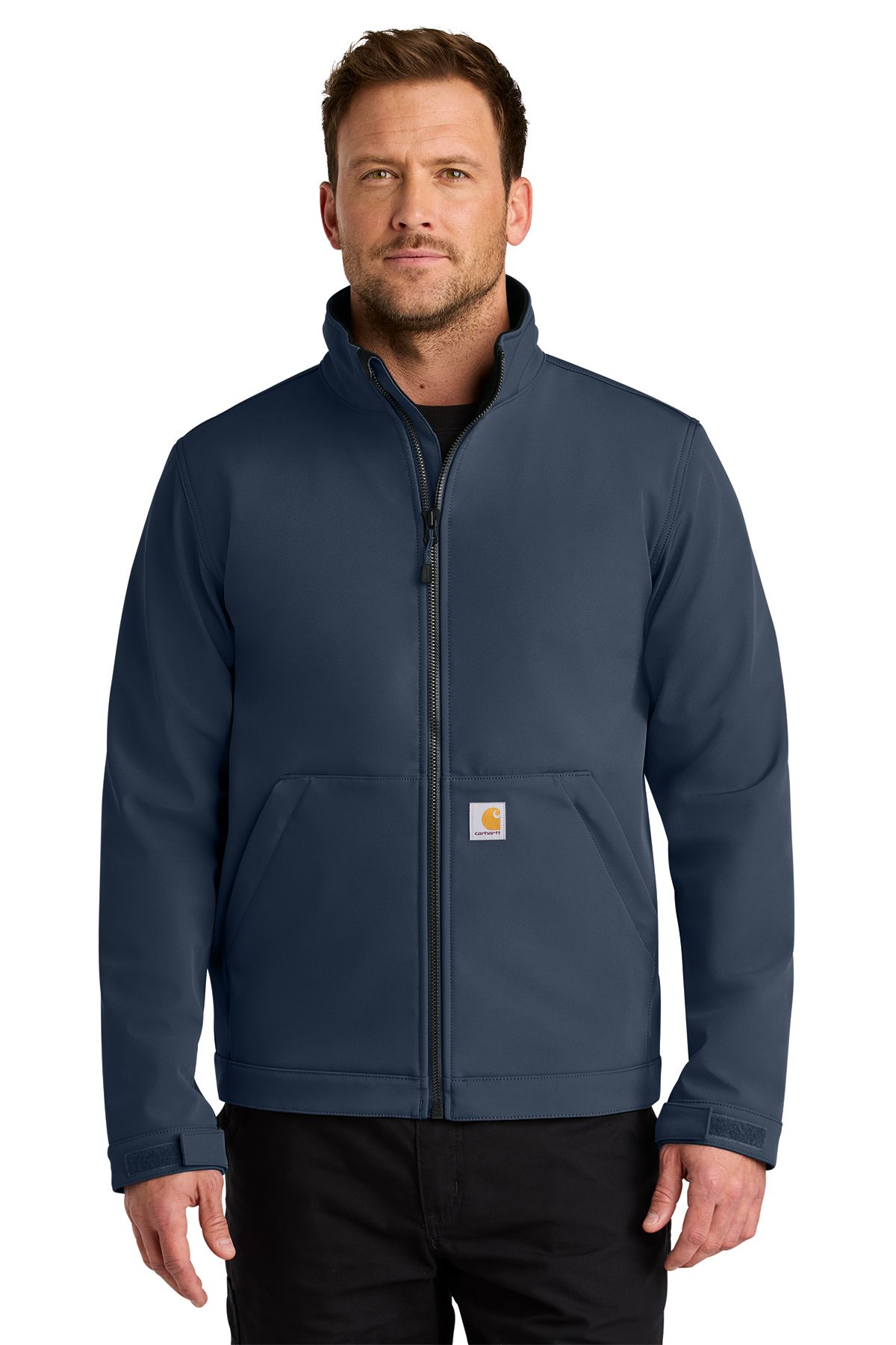 Man wearing a gray Carhartt work jacket, standing indoors.