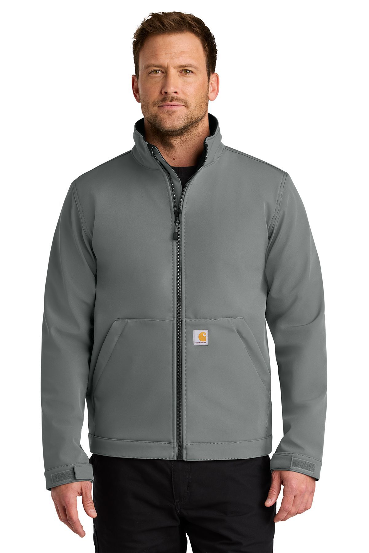 Man wearing a gray Carhartt work jacket, standing indoors.