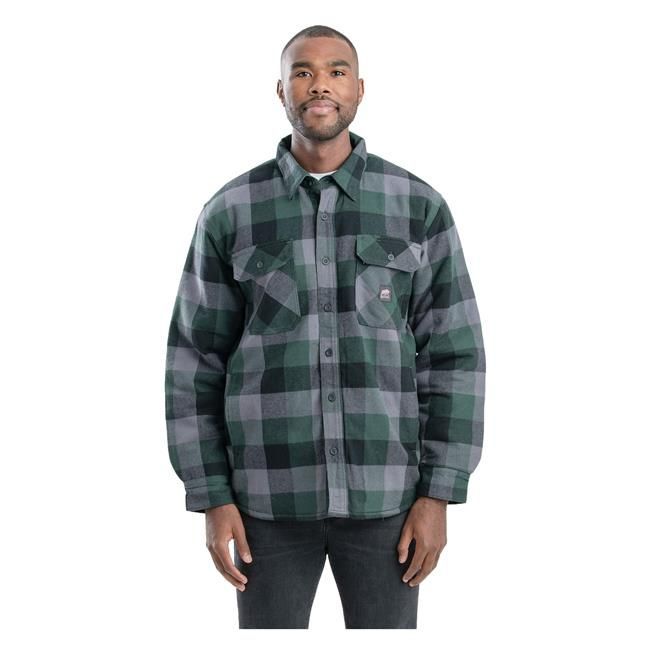 Man wearing a red, gray, and black plaid flannel shirt with a quilted lining, against a white backdrop.