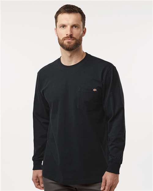 Man wearing a black long-sleeved shirt with a pocket.