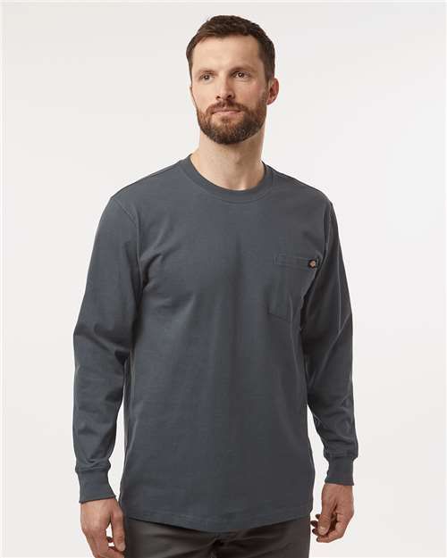 Man wearing a gray long-sleeved shirt with a pocket.