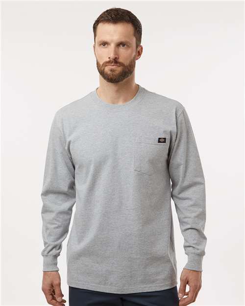 Man wearing a gray long-sleeved shirt with a pocket.