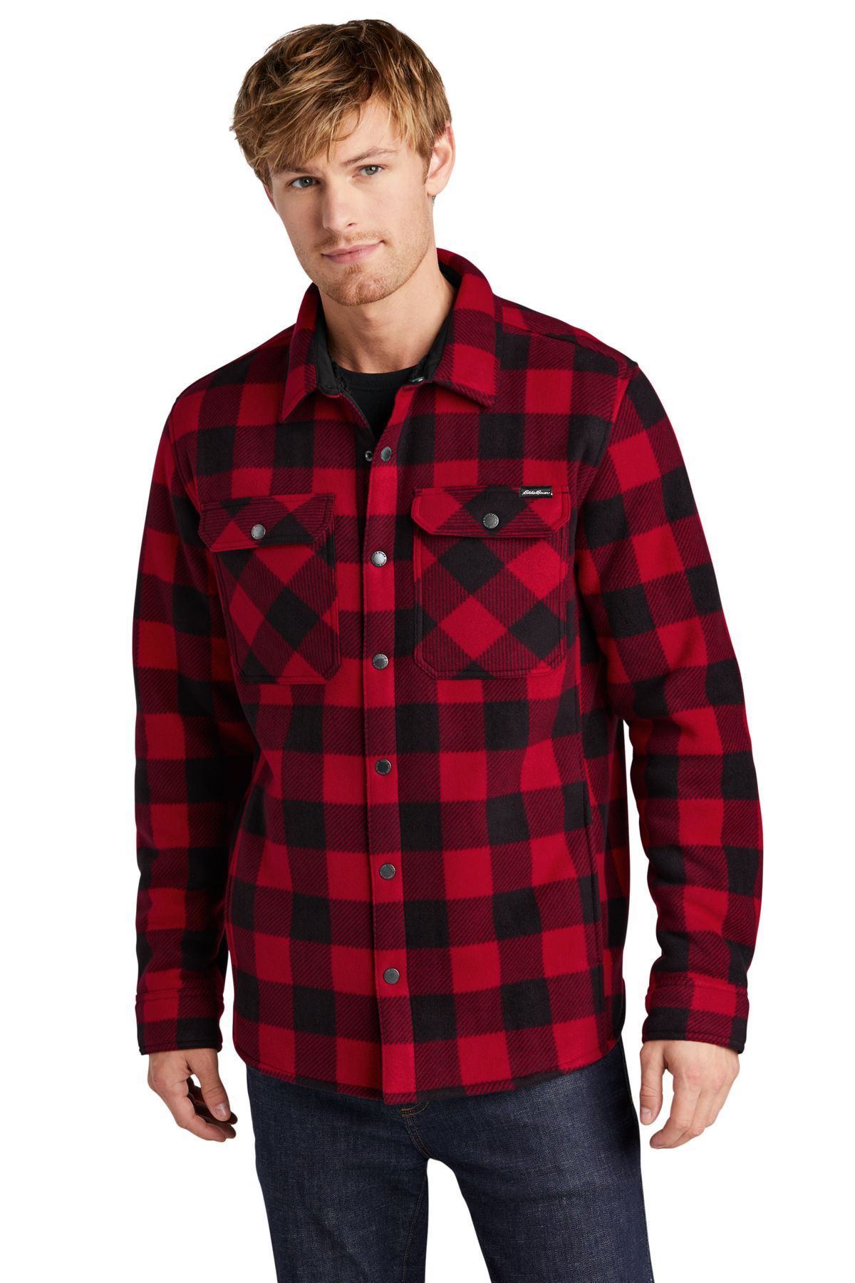 Man wearing a red and black plaid fleece shirt over dark jeans.