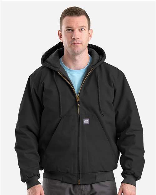 Man wearing a black hooded jacket, zipped up, looking forward.