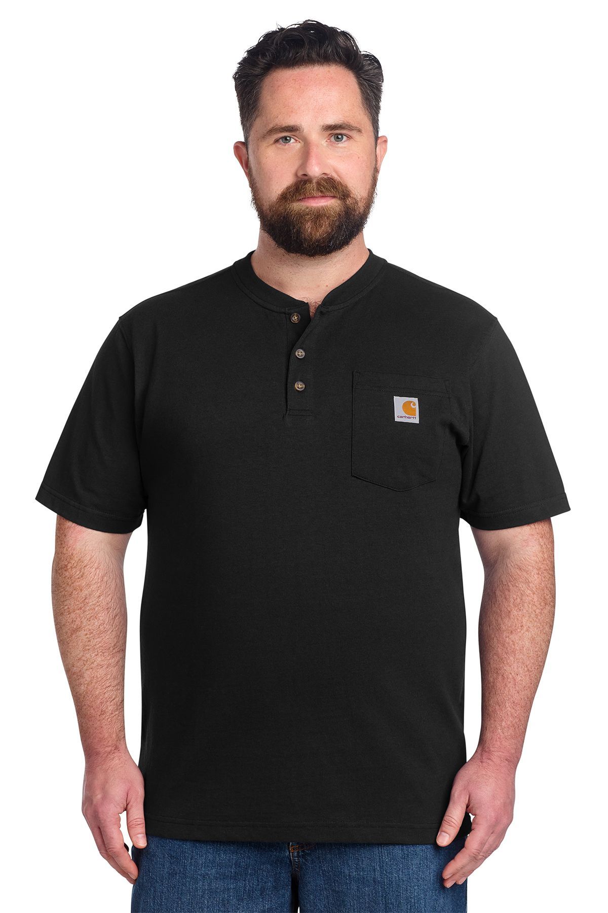 Man in black Carhartt henley shirt, chest pocket, standing, blue jeans.