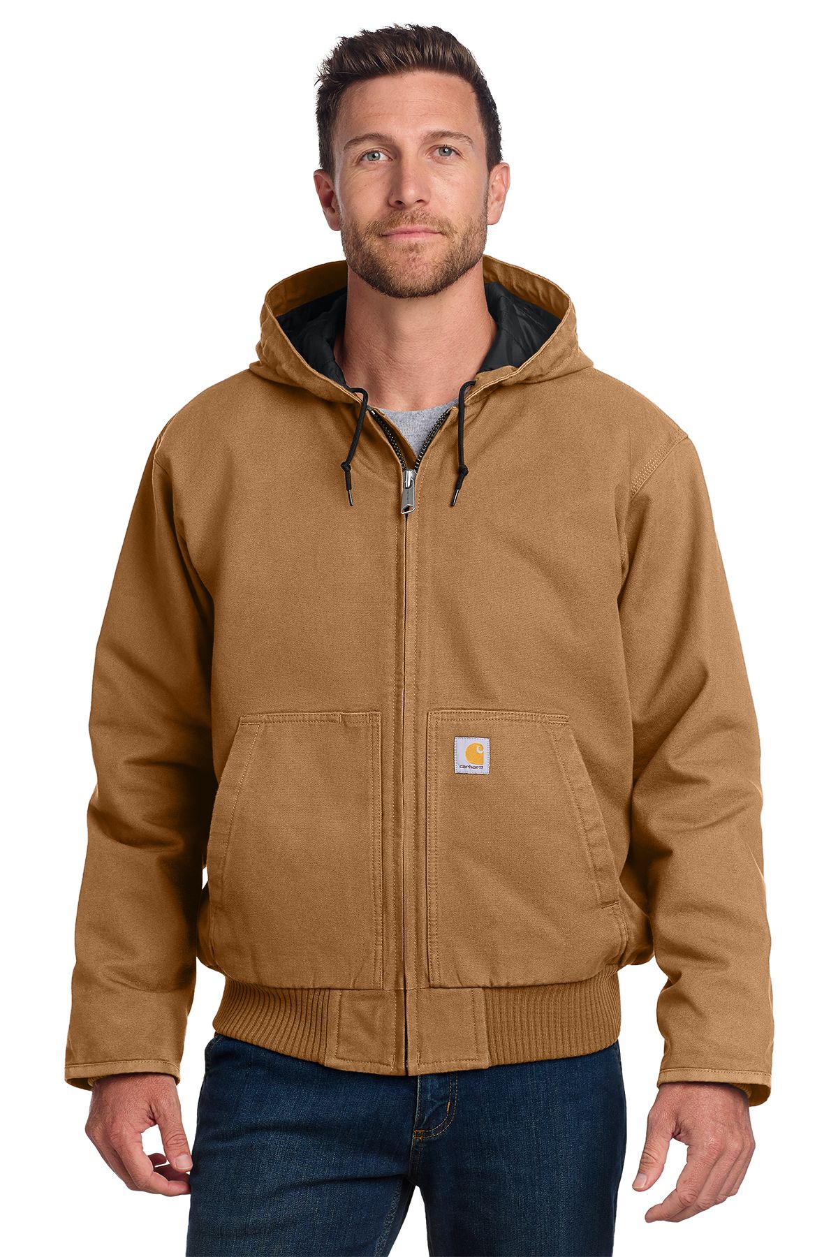 Man in brown hooded Carhartt jacket, dark blue jeans; neutral expression.