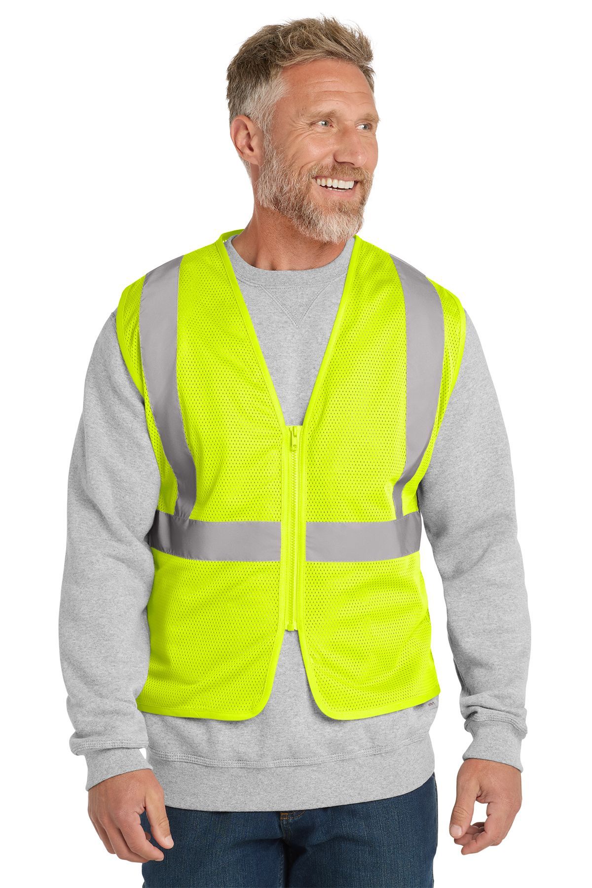 Man wearing an orange safety vest with reflective stripes over a gray sweatshirt, smiling.
