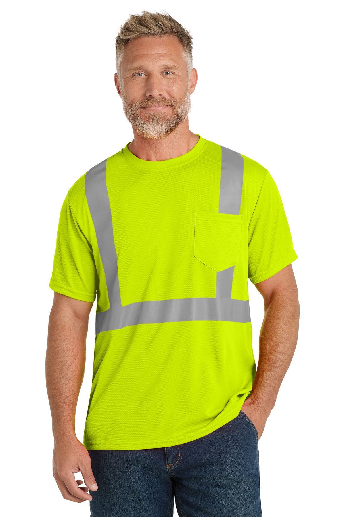 Man wearing a neon green safety shirt with reflective stripes and a pocket, standing.
