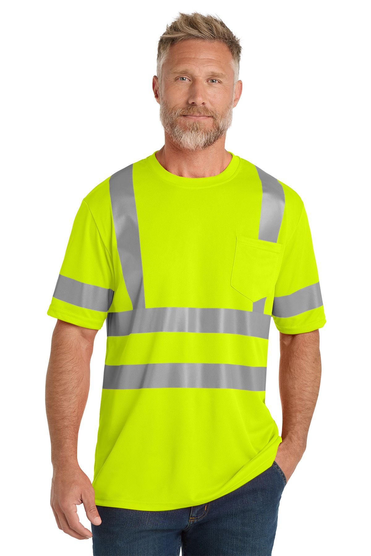 Man wearing a bright orange reflective safety t-shirt, standing with his hand in his pocket.