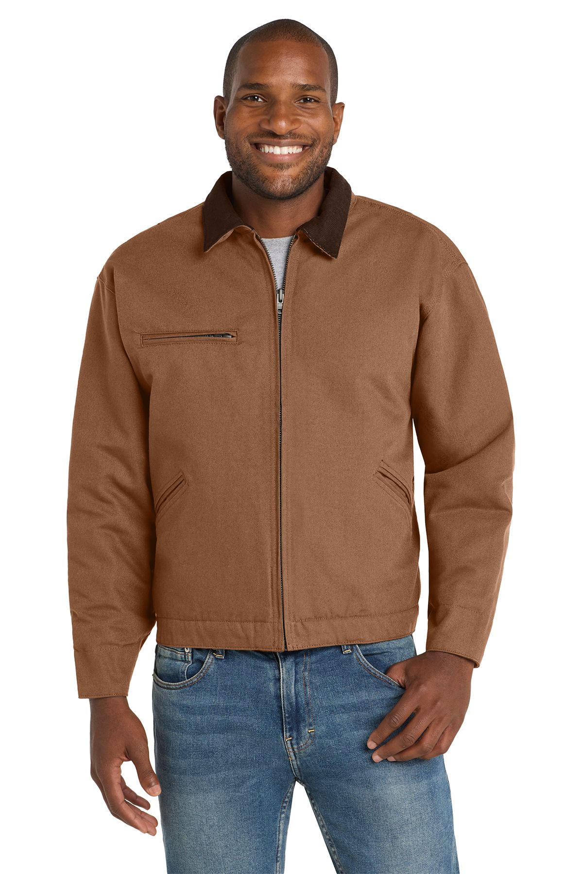 Man wearing a brown work jacket, blue jeans, and a grey shirt; smiles.