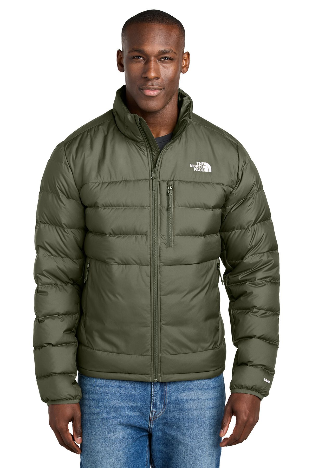 Man wearing a green puffer jacket, standing in front of a white background.