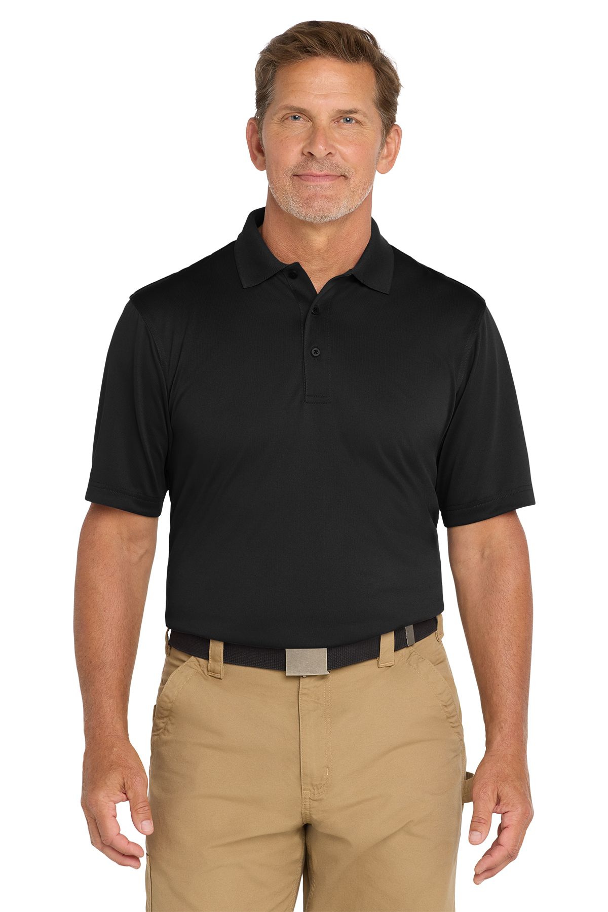 Man in black polo shirt and khaki pants, smiling, standing against a white background.
