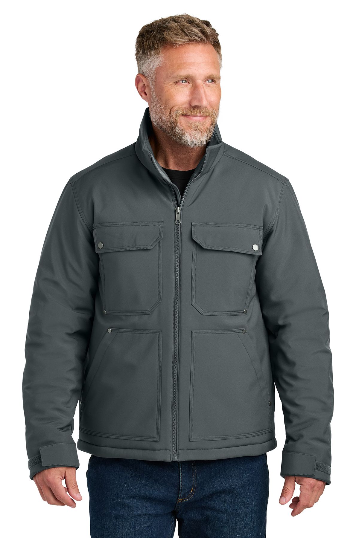 Man wearing a gray insulated jacket with four front pockets, standing outside.