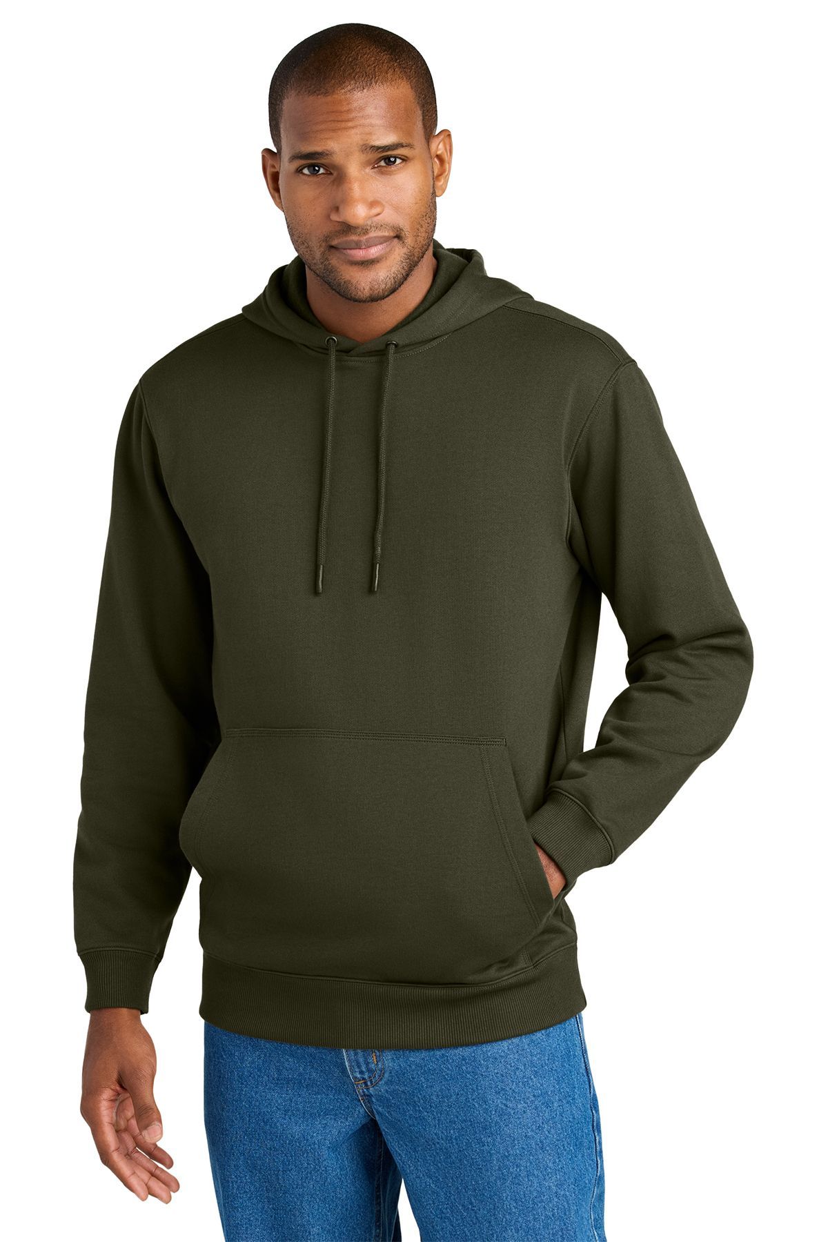 Man in olive green hooded sweatshirt and blue jeans with hand in pocket.