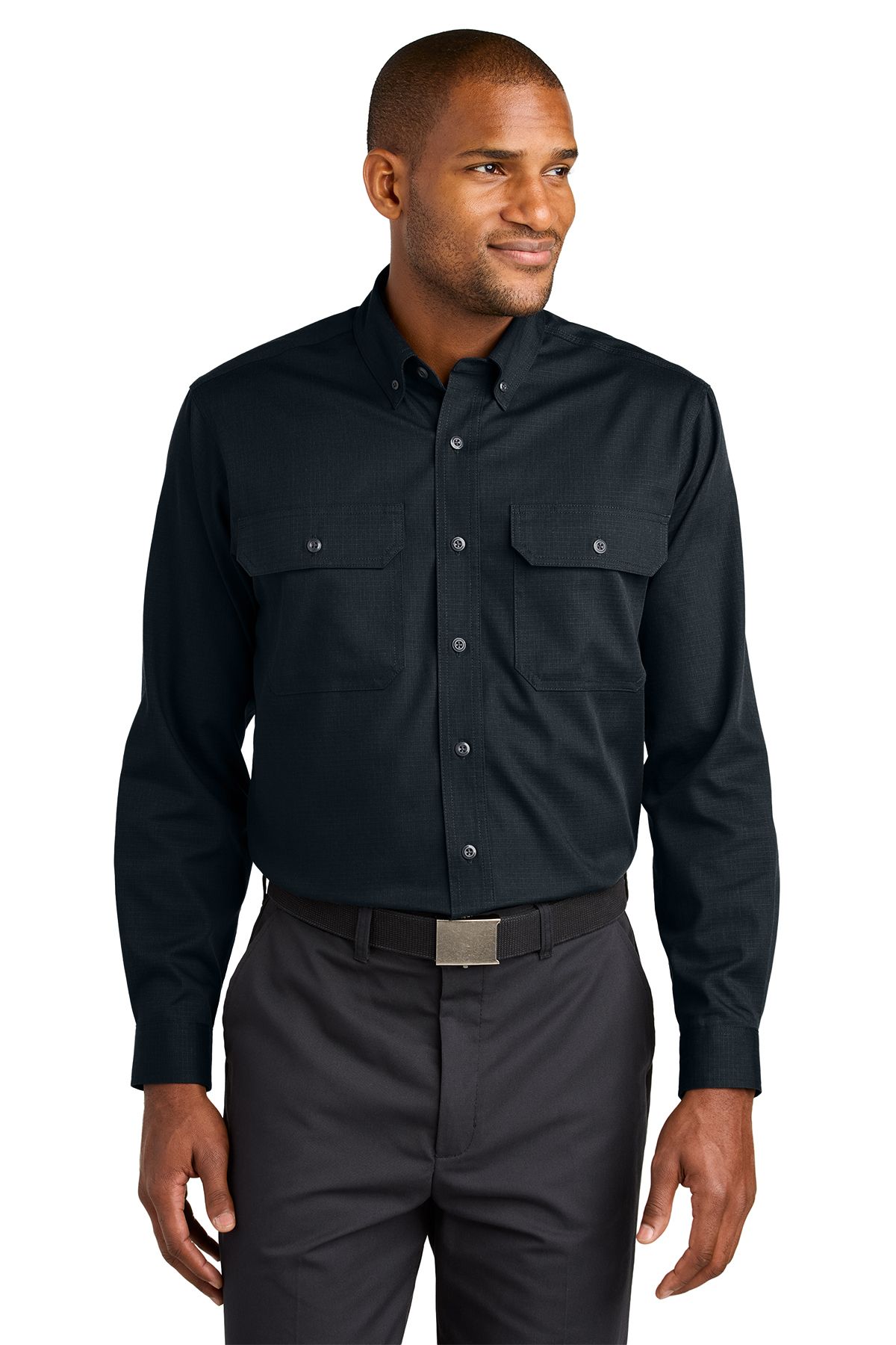 Man in a black long-sleeved shirt and gray pants smiles, standing against a white background.