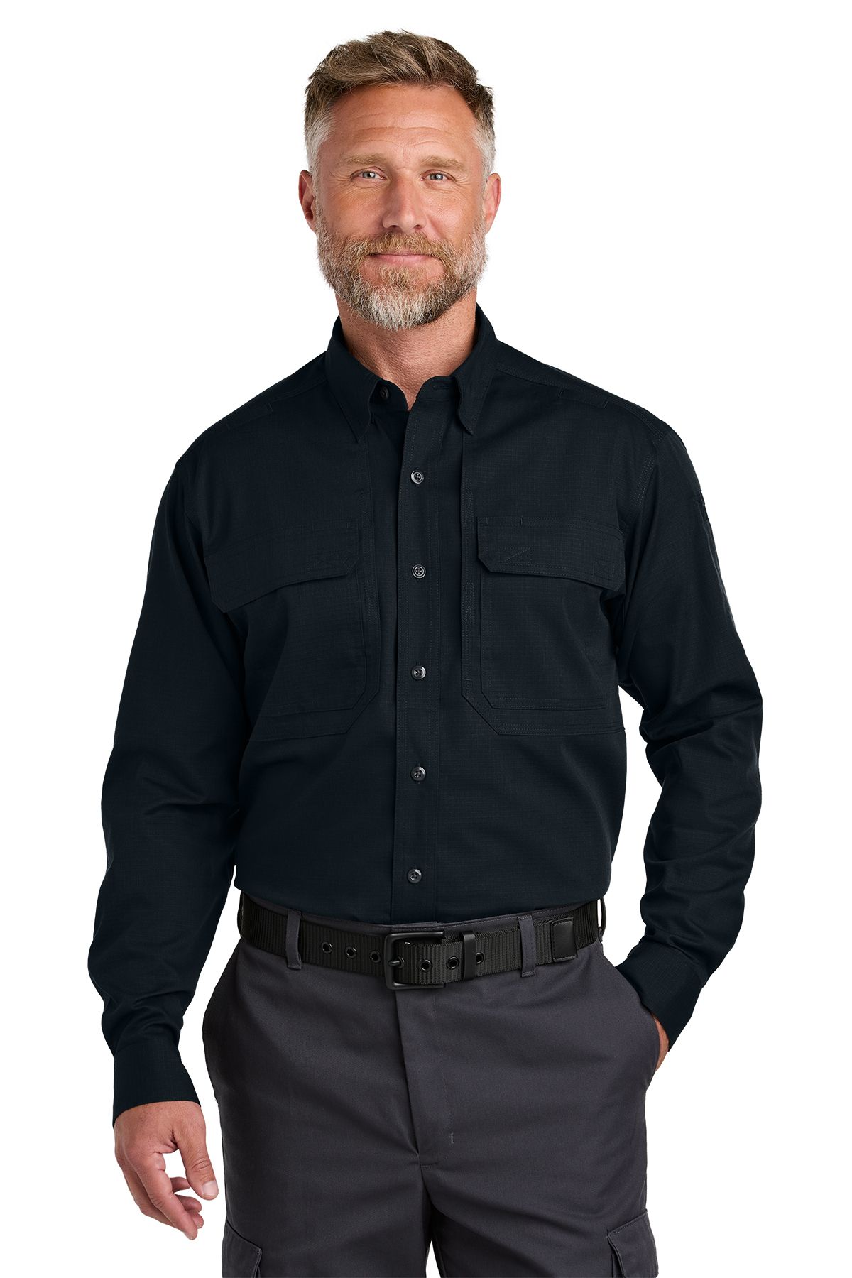 Man in black button-up shirt and gray pants, hands in pockets, standing.