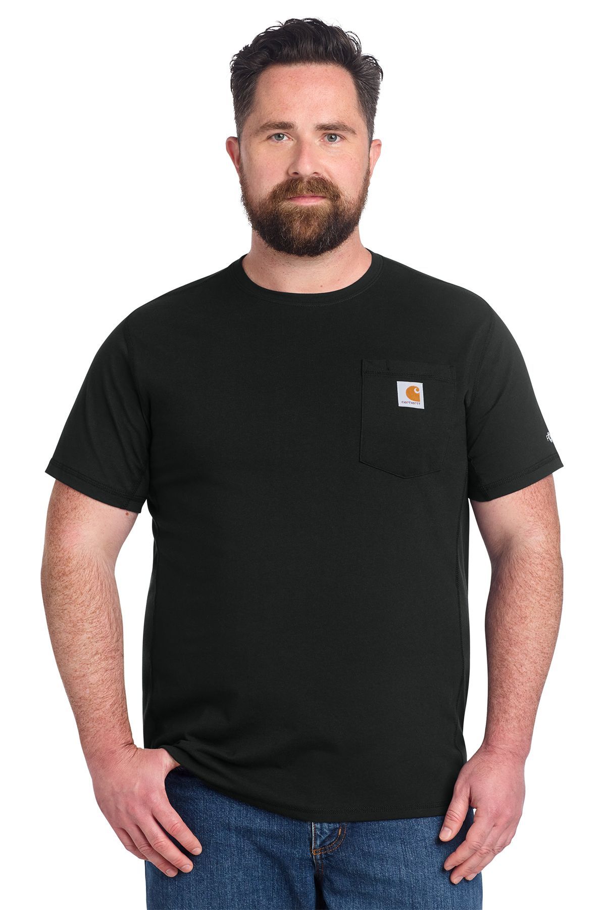 Man wearing a black Carhartt pocket t-shirt and jeans, standing with hands in pockets.