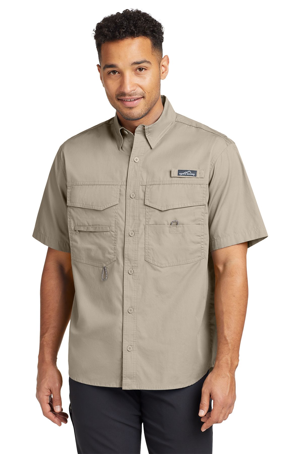 Man wearing a blue short-sleeved fishing shirt, smiling.