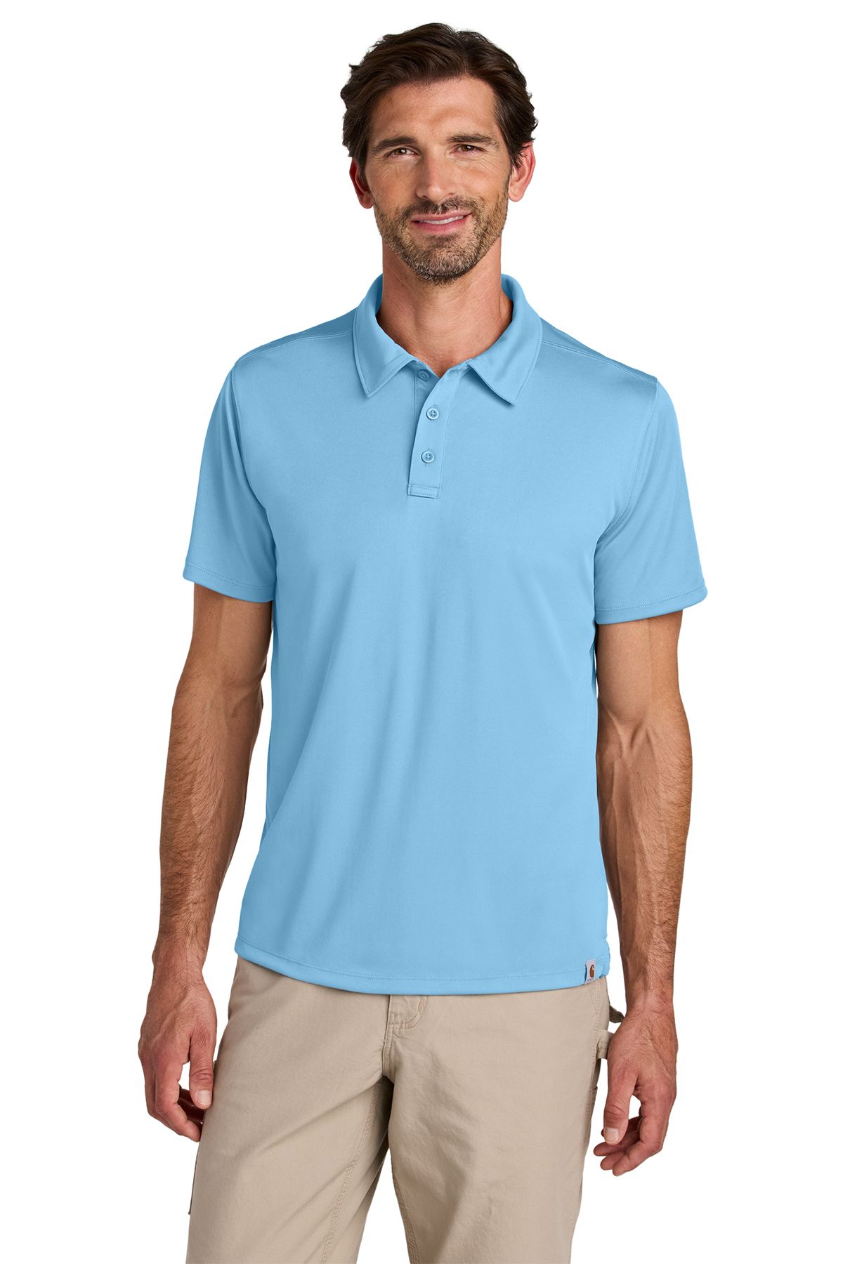 Man wearing a light blue polo shirt and khaki pants, smiling.