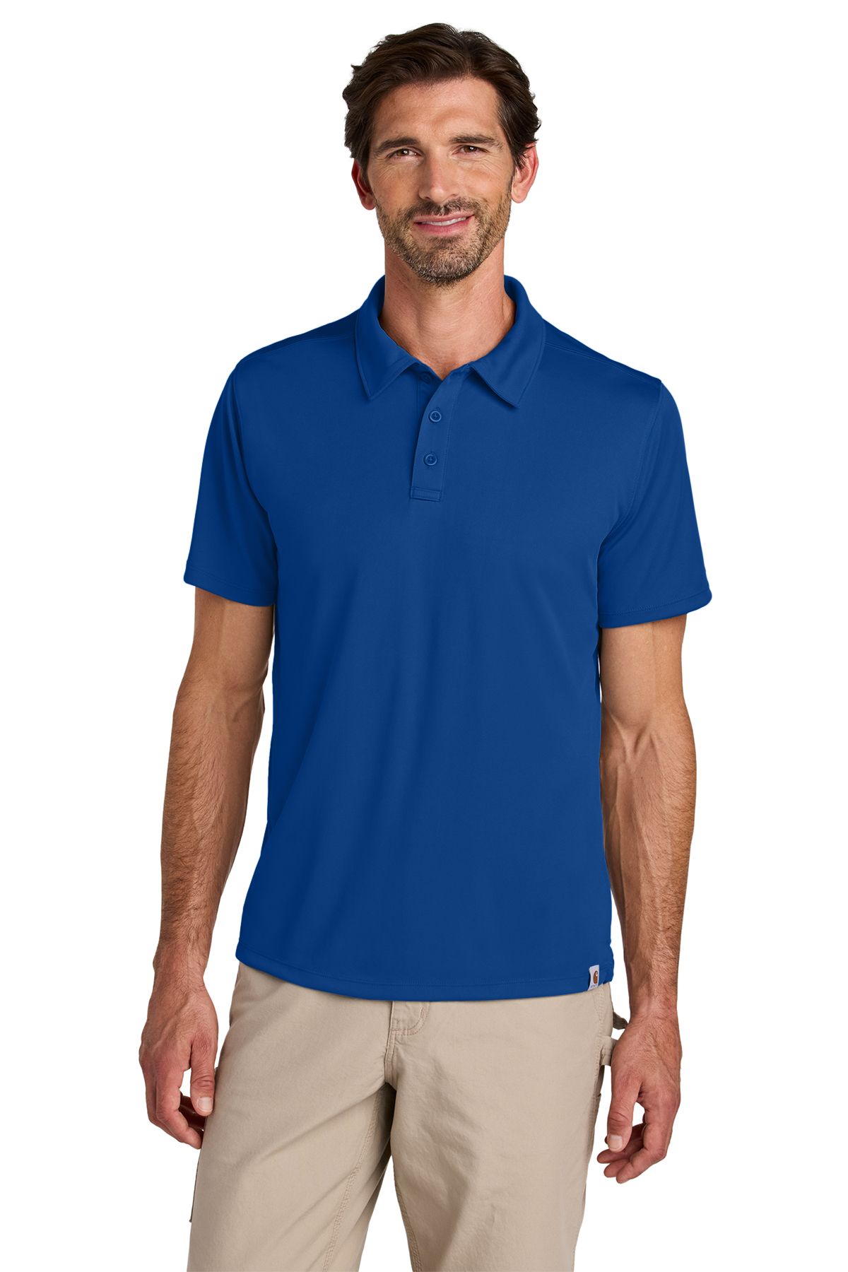 Man wearing a light blue polo shirt and khaki pants, smiling.