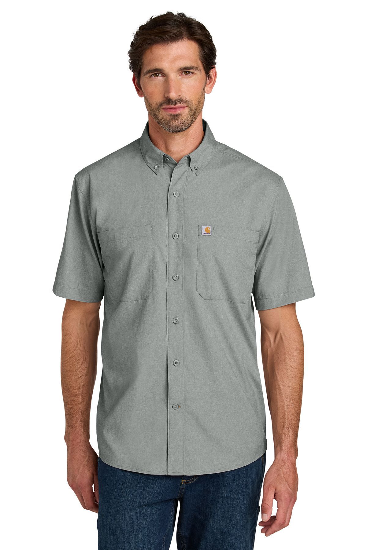 Man wearing a light blue short-sleeved button-down shirt over blue jeans.