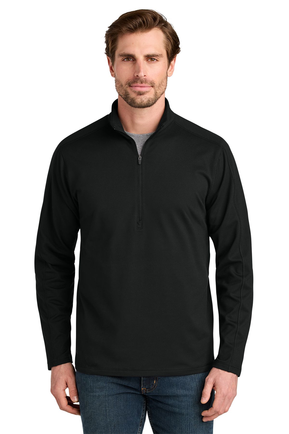 Man in black quarter-zip sweatshirt and jeans, looking forward, neutral expression.