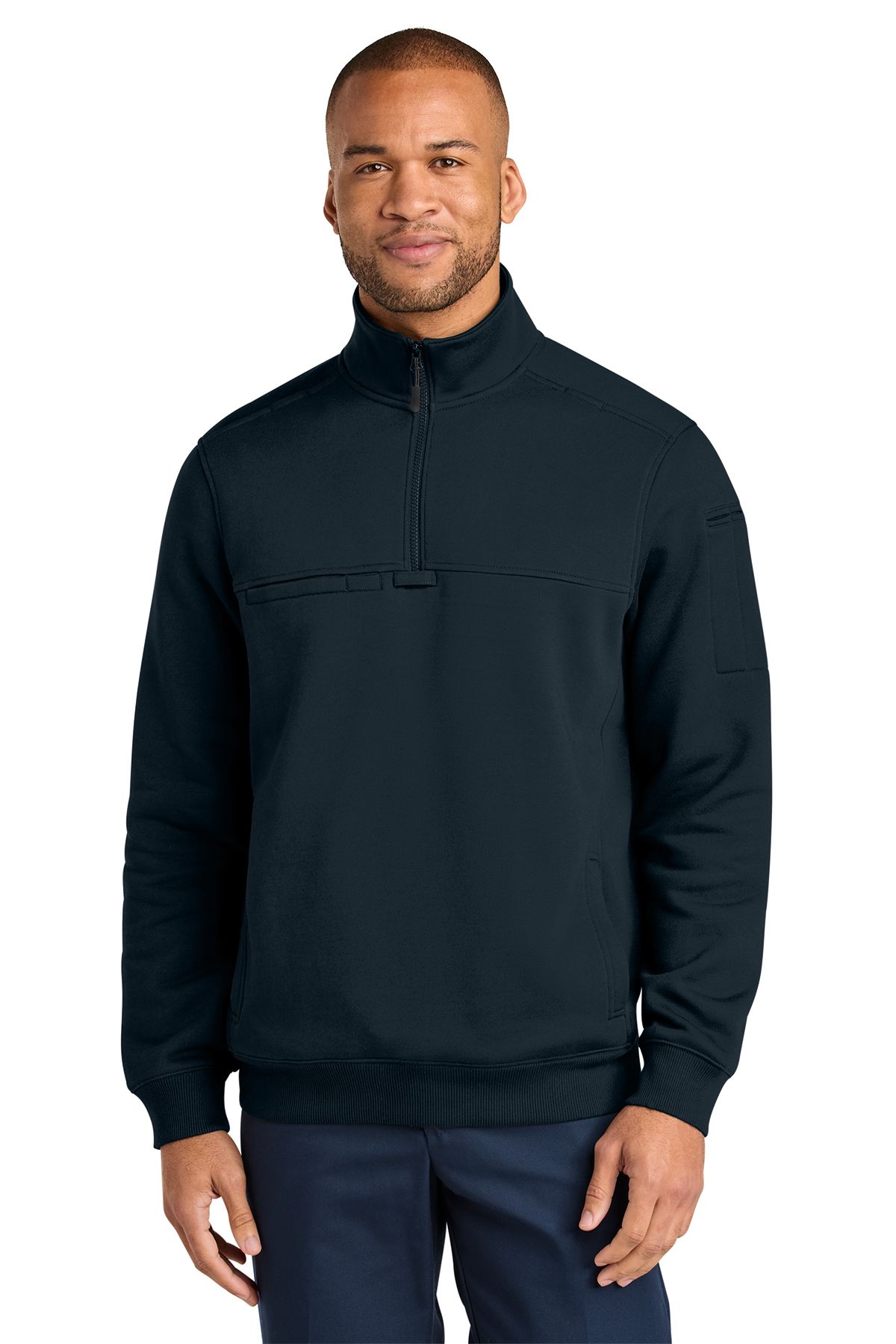 Man in navy blue jacket and pants, smiling. Jacket has high collar and snap closure.