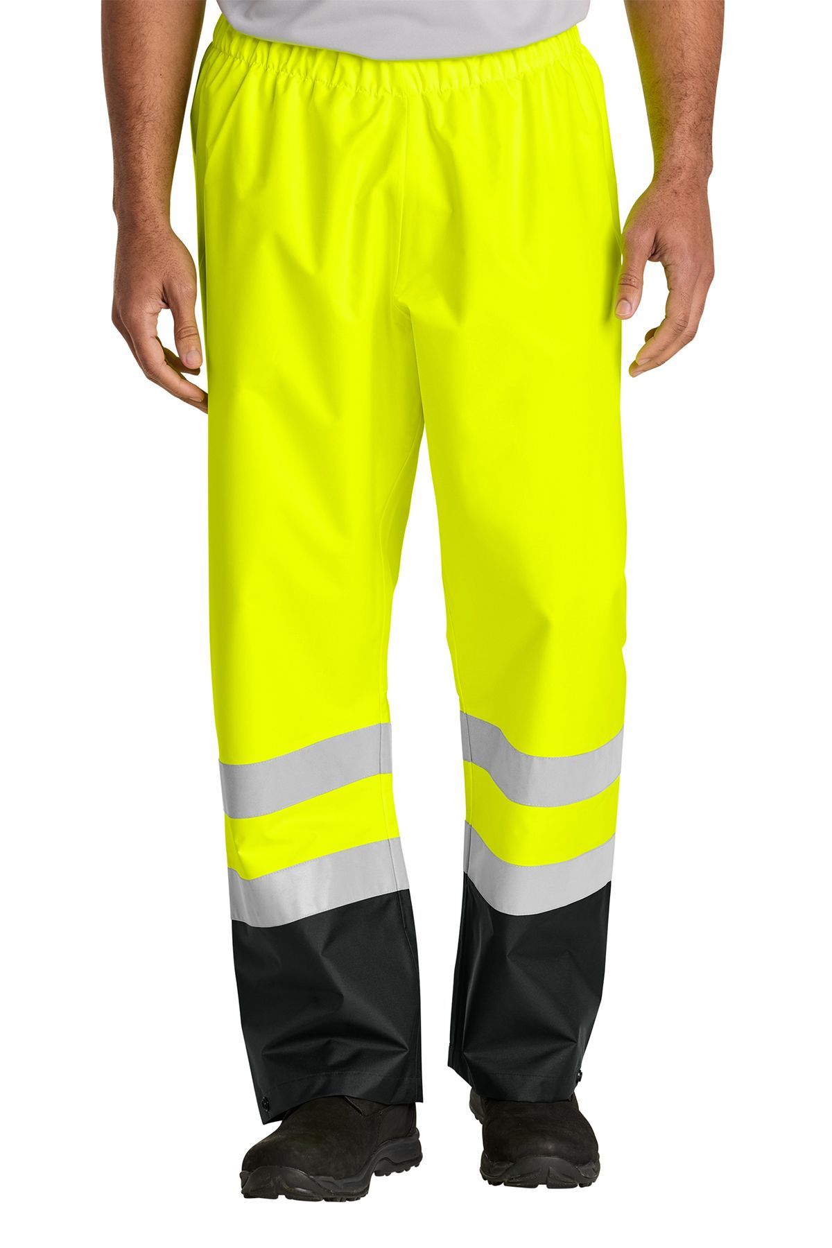 Man wearing bright yellow rain pants with reflective stripes and black lower legs.