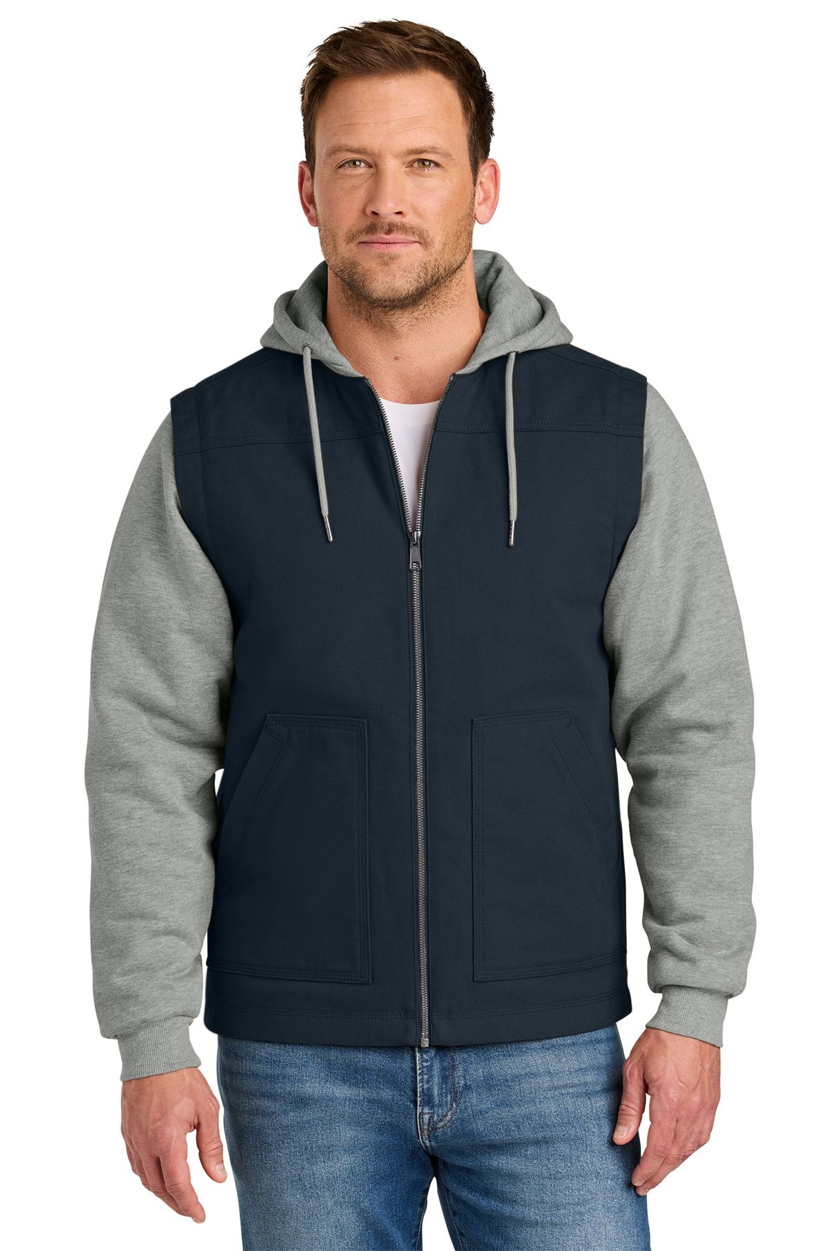 Man in navy vest with gray hoodie and sleeves, blue jeans.