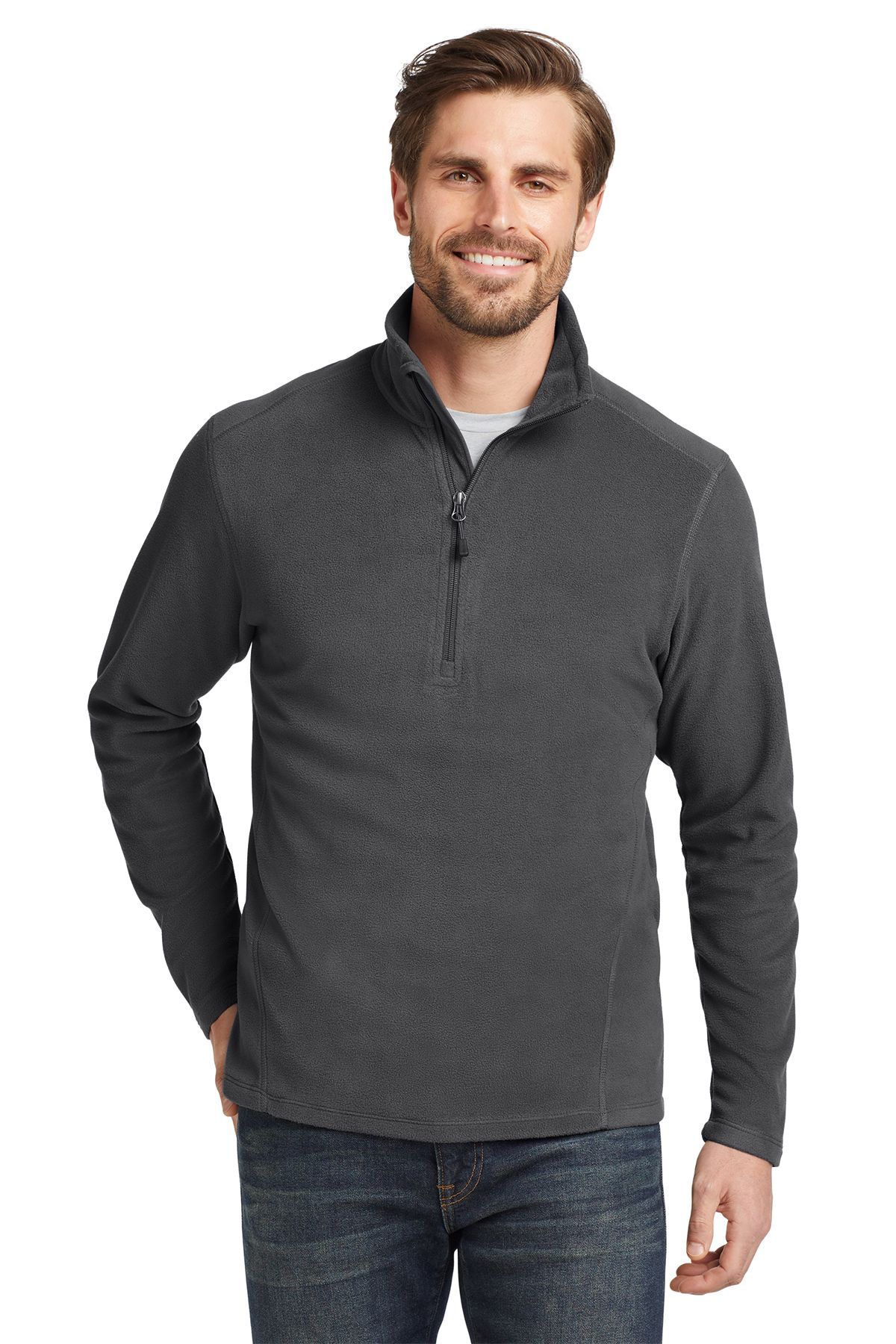 Man wearing a dark gray fleece quarter-zip sweater and jeans, smiling.