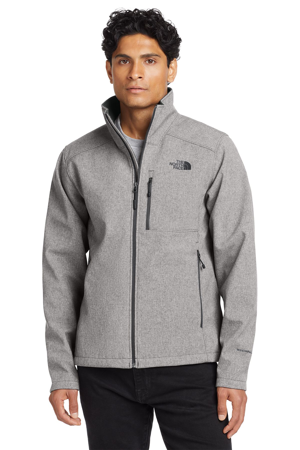 Man wearing a blue North Face jacket, smiling, standing in front of a white backdrop.