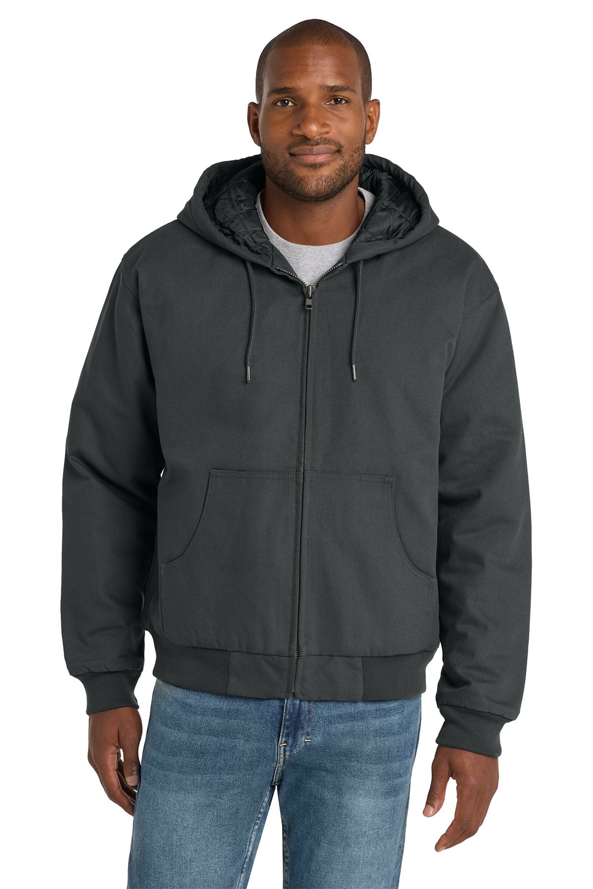Man in a dark gray hooded jacket, zipped up, and blue jeans.