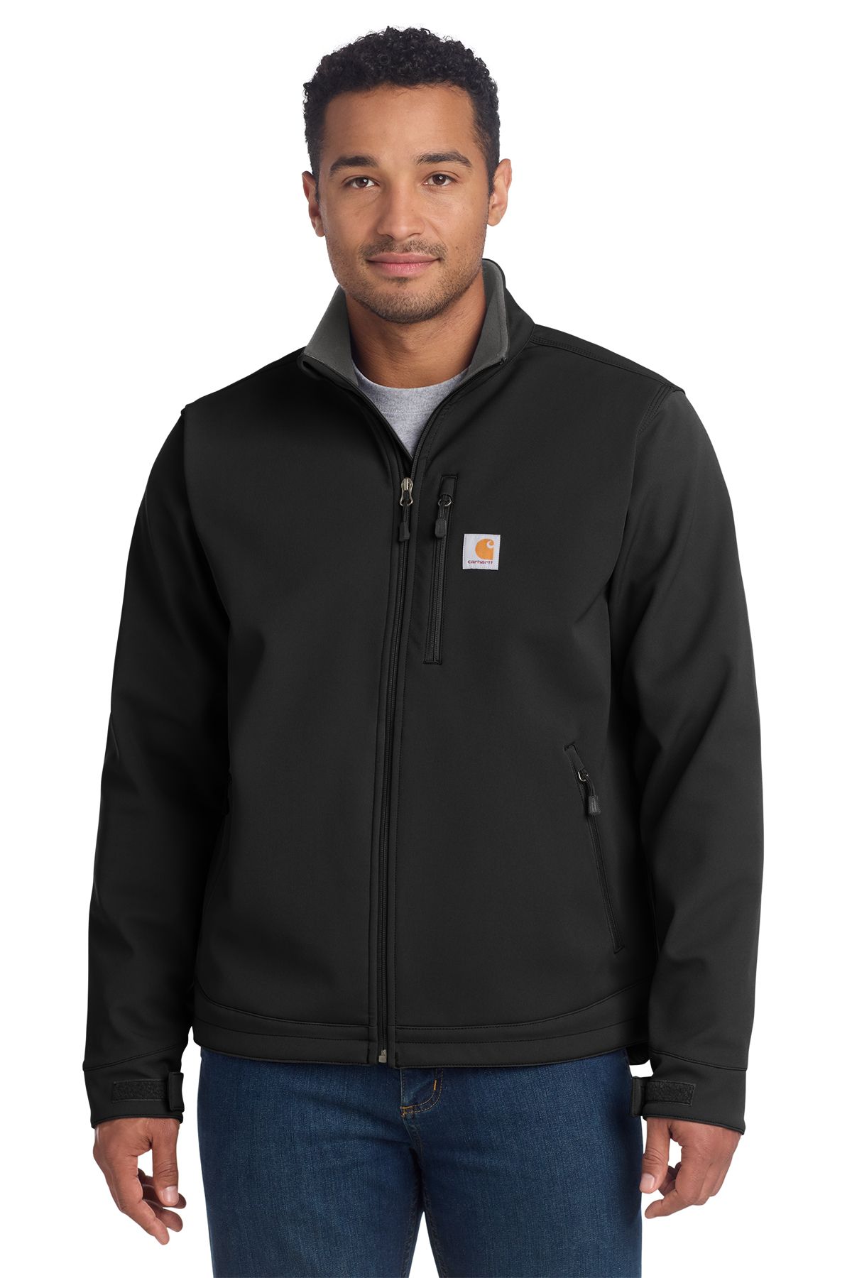 Man in gray Carhartt jacket, standing, full-zip. Black collar and pocket accents, jeans.