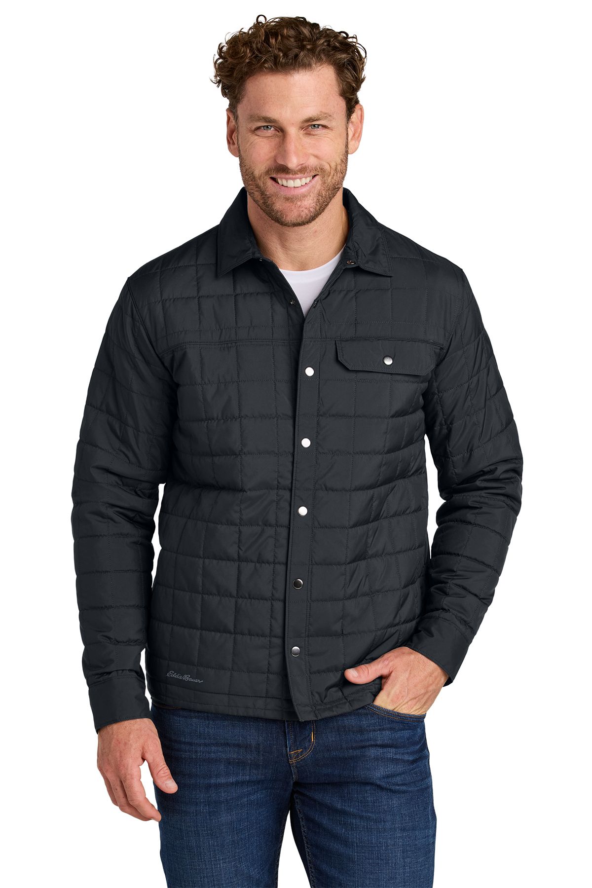 Man wearing a quilted gray shirt jacket over a button-down shirt, with blue jeans.