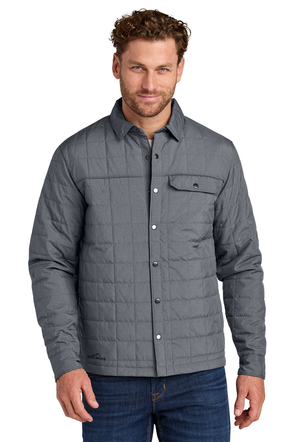 Man wearing a quilted gray shirt jacket over a button-down shirt, with blue jeans.