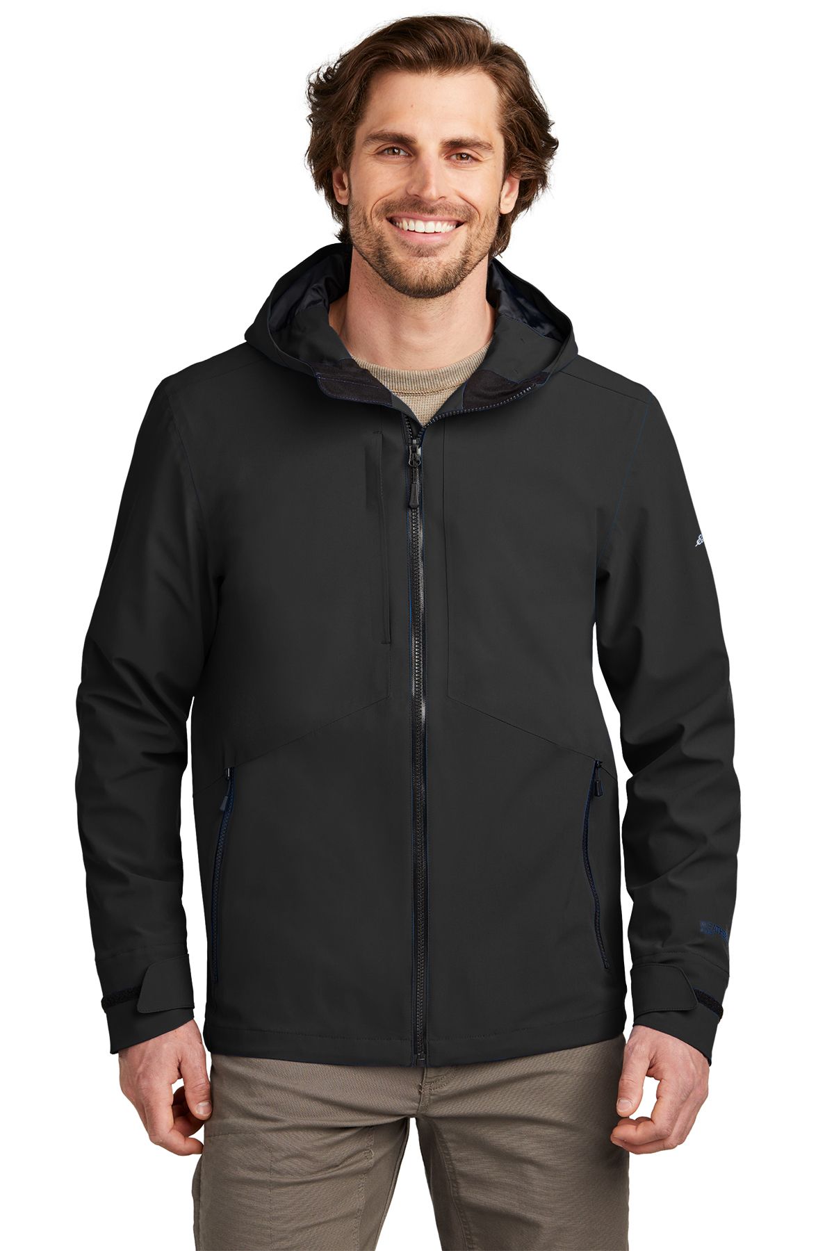 Man wearing a black hooded jacket, smiling.